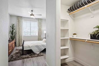 a bedroom with a bed and a ceiling fan